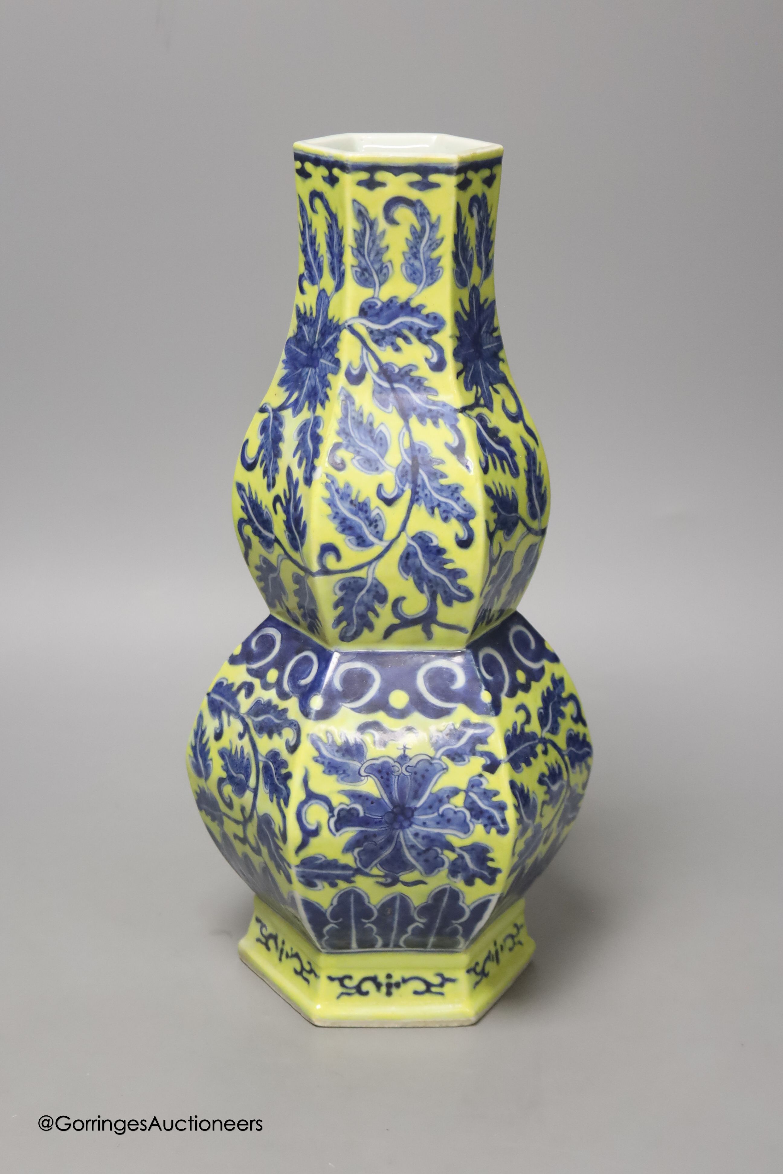 A Chinese underglaze blue yellow ground hexagonal vase, early 20th century, some restoration 35cm